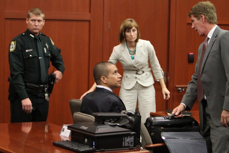 George Zimmerman, center, speaks with his attorney Mark O'Mara during an April 20 bond hearing at the Seminole County Courthouse in Sanford, Fla.