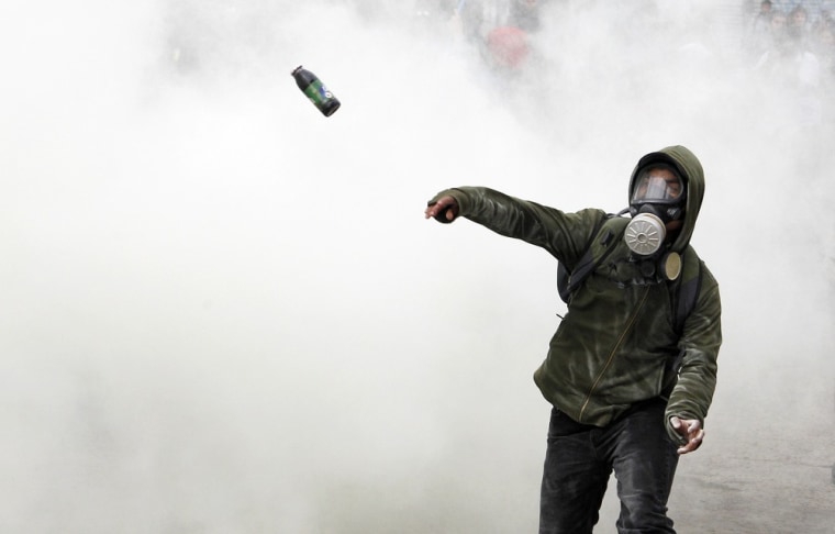 A student throws a bottle of paint during a protest against the government to demand changes in the public state education system in Valparaiso city, about 75 miles northwest of Santiago, Chile on April 25.
