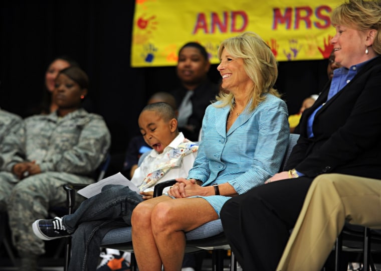 Jaelen Franco, center, a student at Lee Hall Elementary who was chosen to introduce Dr. Jill Biden, Second Lady of the United States, seated to his left, yawns while listening to remarks by Admiral James E. Winnefeld, Vice Chairman of the Joint Chiefs of Staff, during a program to honor military families at the school in Newport News, Va. on April 25.