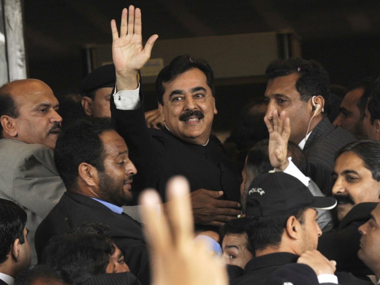 Pakistan's Prime Minister Yusuf Raza Gilani waves to supporters upon arrival at the Supreme Court for a hearing in a contempt-of-court of notice, in Islamabad, Thursday.
