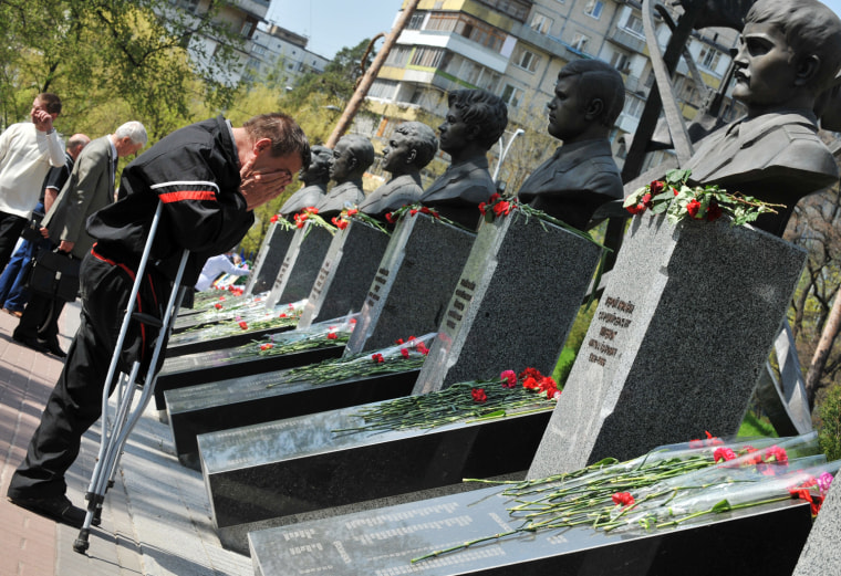 A Chernobyl's handicapped person cries in front of the Chernobyl victims memorial in Kiev during a memorial ceremony on April 26. Ukraine launched today construction of a new shelter to permanently secure the stricken Chernobyl plant as it marked the 26th anniversary of the world's worst nuclear disaster.