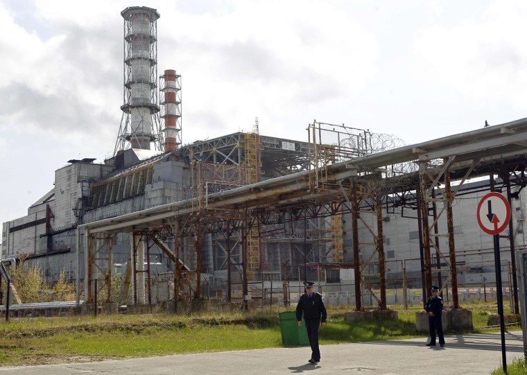 Men walk near a containment shelter for the damaged fourth reactor at the Chernobyl nuclear power plant on April 26. Belarus, Ukraine and Russia mark the 26th anniversary of the Chernobyl disaster, the world's worst civil nuclear accident, on Thursday.