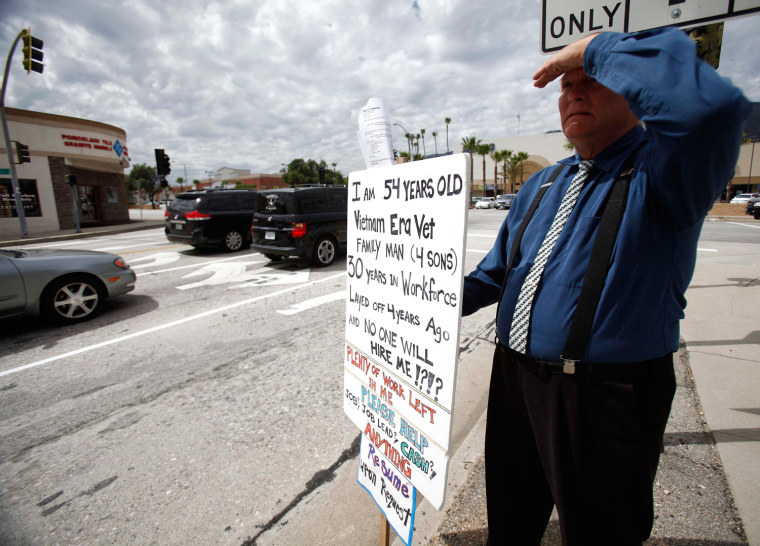 Kelly Edwards, 54, who was laid off 4 years ago, holds a sign at a street corner in Pasadena, California April 25, 2012. Edwards has resorted to handing out resumes at street corners and accepting money from strangers to provide for his family.