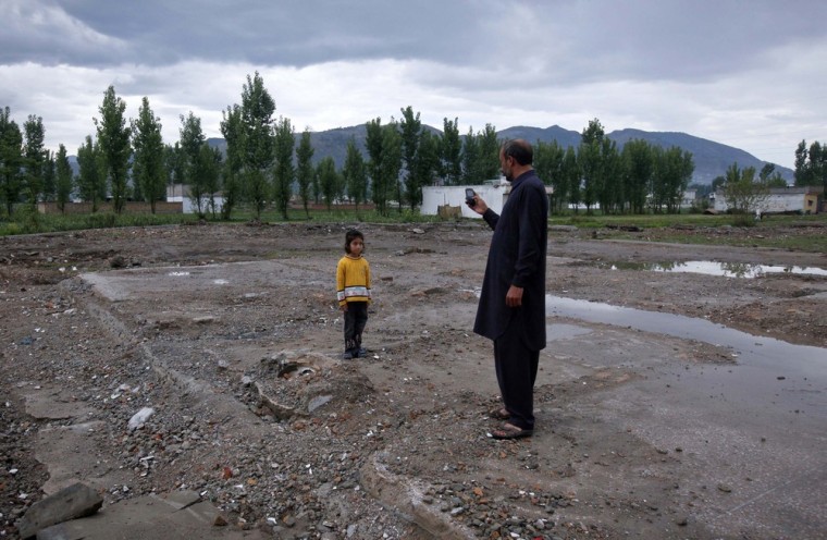 Six-year-old Anum, poses for her uncle for a picture while visiting the site of the demolished compound of Osama bin Laden in Abbottabad. Osama bin Laden was killed in Abbottabad almost a year ago, on May 2. All photographs captured by Reuters photographer Akhtar Soomro between April 20-23.