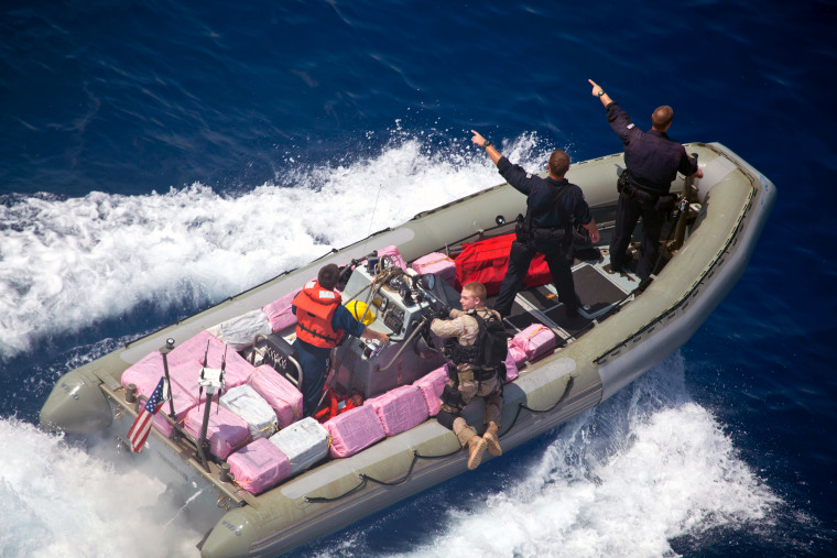 U.S Navy and Coast Guard personnel, transport bales of cocaine seized from drug runners in the Caribbean Sea last Friday.