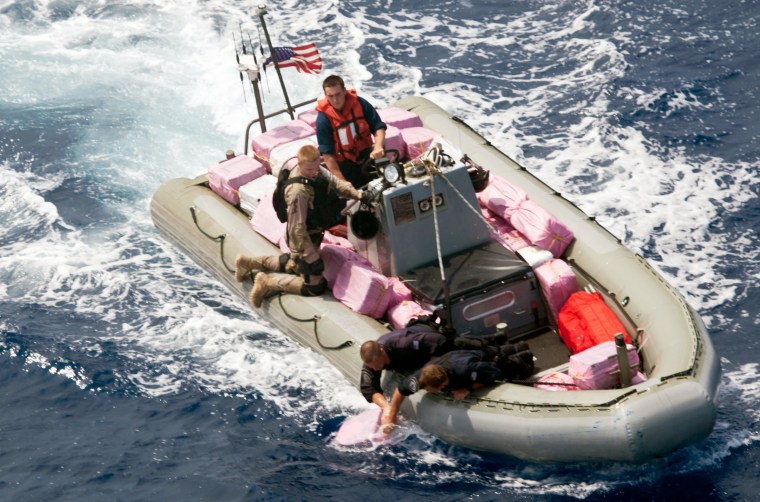 U.S Navy and Coast Guard personnel pick up bales of narcotics out of the Caribbean Sea last Friday.