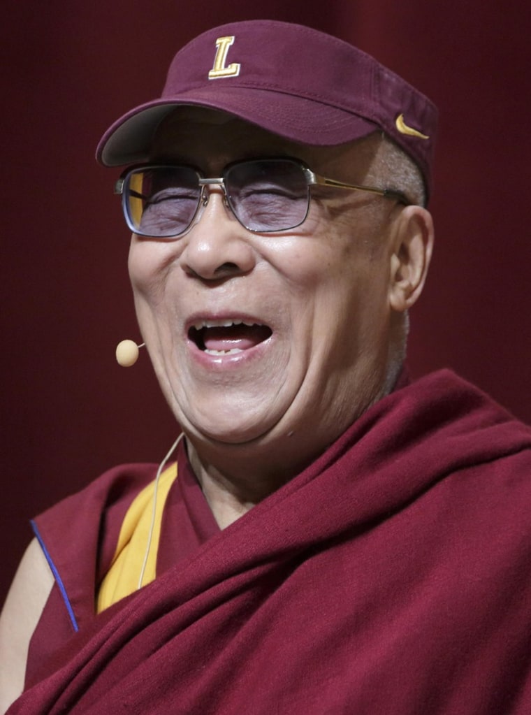 His Holiness the 14th Dalai Lama of Tibet laughs while wearing a Loyola University visor during a speech on non-violence at the university's Lake Shore Campus in Chicago on April 26.  The Dalai Lama, who was in Chicago for the three-day World Summit of Nobel Peace Laureates, received an honorary degree from Loyola.