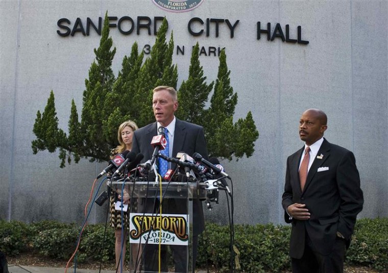 City Manager Norton Bonaparte Jr. stands by at right while Mayor Jeff Triplett speaks recently about the Trayvon Martin case in Sanford, Fla.