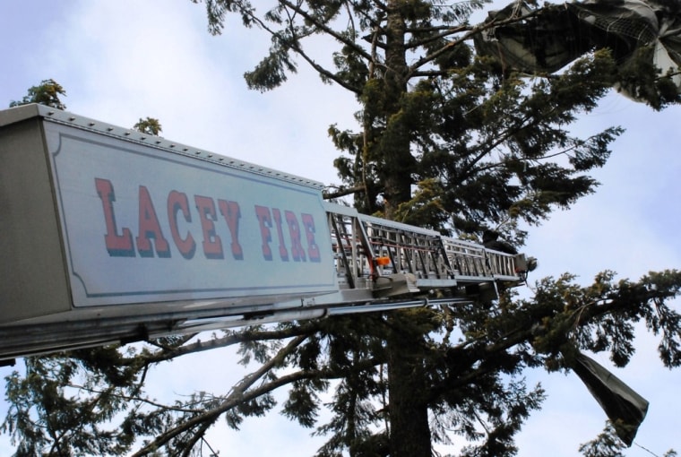 Lacey Fire District Three's tall ladder being used to reach one of the trapped paratroopers.
