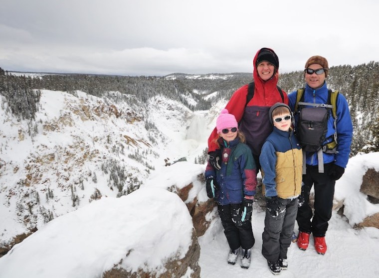 Michael Lanza, his wife, Penny Beach, and their children Alex, left, and Nate overlook Lower Yellowstone Falls in Yellowstone National Park, which they skied to in Jan. 2011.