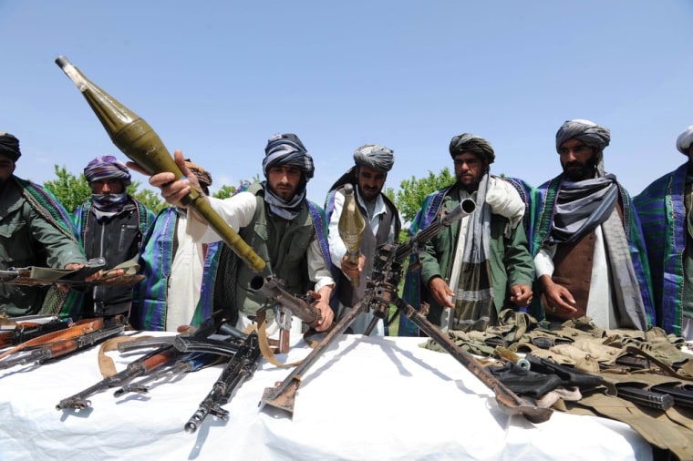 Former Taliban fighters display their weapons as they join Afghan government forces during a ceremony in Herat province Thursday.