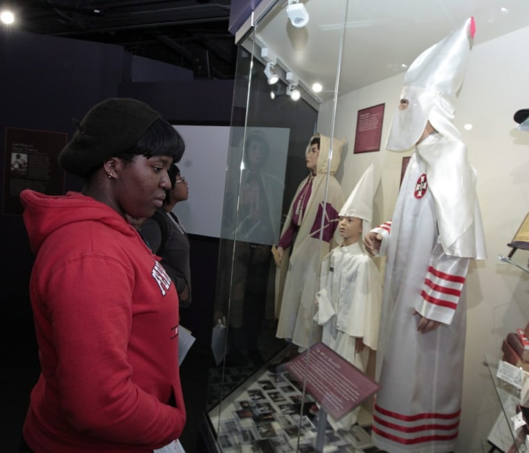 Blessing Efere looks at Ku Klux Klan items on display at the Jim Crow Museum of Racist Memorabilia located at Ferris State University in Big Rapids, Michigan on Friday. The museum's goal is to use objects of intolerance to teach tolerance and promote social justice. In the 1830s and '40s, the white entertainer Thomas Dartmouth Rice performed a popular song-and-dance act supposedly modeled after a slave. He named the character Jim Crow. After the American Civil War (1861-1865), most southern states and, later, border states passed laws that denied blacks basic human rights. It is not clear how, but the minstrel character's name 'Jim Crow' became a kind of shorthand for the laws, customs and etiquette that segregated and demeaned African Americans primarily from the 1870s to the 1960s.