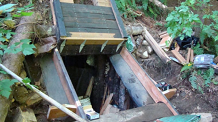 Authorities believe a survivalist suspected of killing his wife and daughter fled to this underground bunker in the woods east of Seattle.