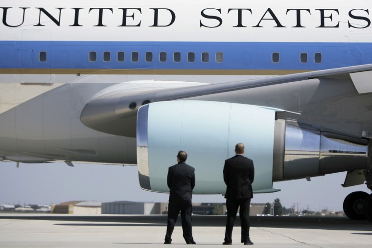 Secret Service agents watch as Air Force One departs Midland International Airport with President Bush and first lady Laura Bush aboard in Midland, Texas, on Oct. 4, 2008.