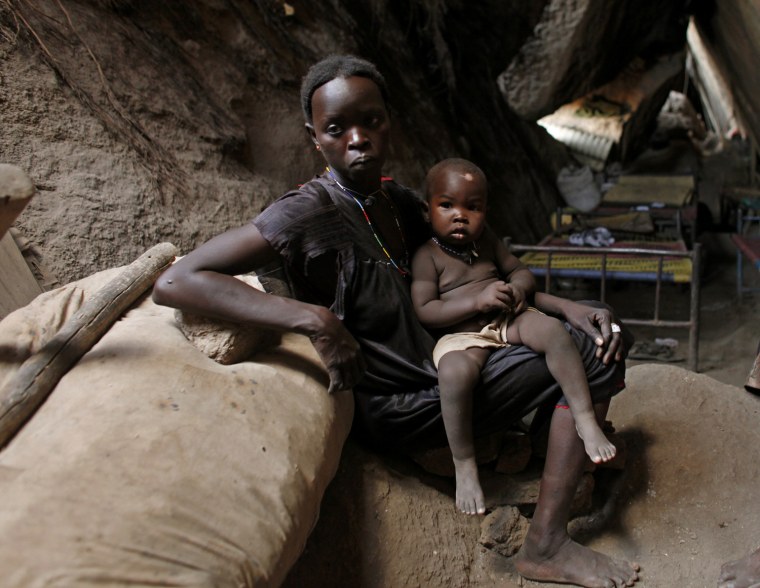 A woman holds her child in a cave in Bram village in the Nuba Mountains, South Kordofan, April 28.