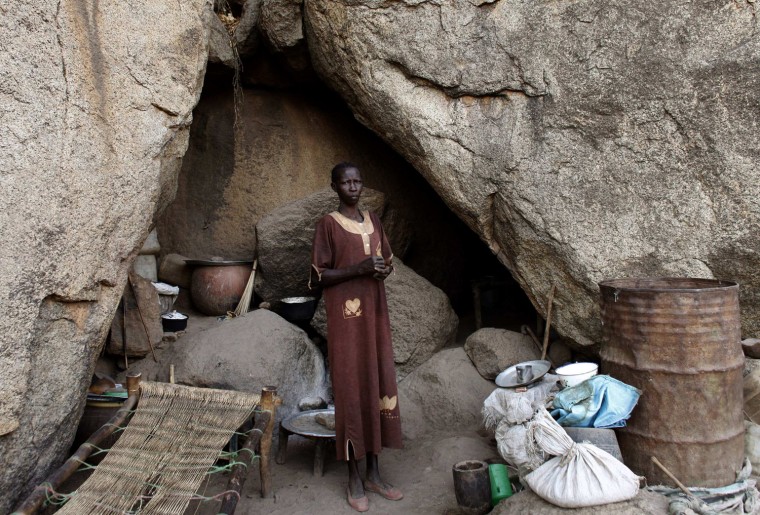 A woman stands in front of her shelter in Bram village in the Nuba Mountains in South Kordofan.