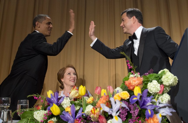 US President Barack Obama high-fives television host Jimmy Kimmel, right, alongside Caren Bohan, center, of Reuters, President of the White House Correspondents Association during the White House Correspondents Association Dinner in Washington, D.C., April 28. The annual event, which brings together President Barack Obama, Hollywood celebrities, news media personalities and Washington correspondents, featured comedian Jimmy Kimmel as the host.