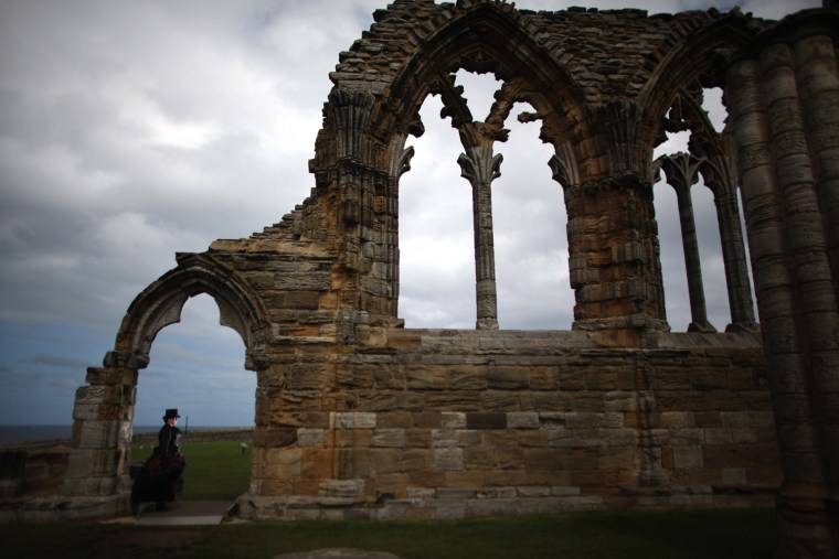 Victoriana fan Jan Farmer poses outside Whitby Abbey during the Whitby Goth Weekend on April 28, in Whitby, England.