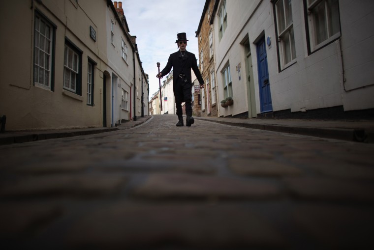 Goth Jimmy Clarke walks in the narrow fishermens' streets during Whitby Goth Weekend.