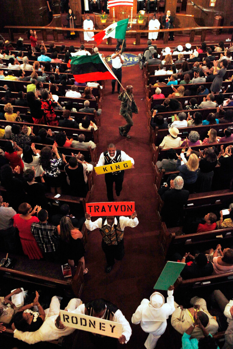 Churchgoers perform as they dance with signs and flags during Sunday service at First AME Church in Los Angeles, Calif., April 29. The Rev. Al Sharpton delivered the sermon.