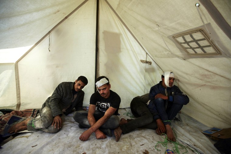 Four men, who witnesses say were perpetrators of an attack on followers of an Egyptian Muslim cleric and former candidate for the Egyptian presidency, are seen detained in a tent by Salafi protesters near the Ministry of Defense after overnight clashes in Cairo, Egypt, April 29. Assailants attacked demonstrators gathered outside the Defense Ministry in Egypt's capital to call for an end to military rule with rocks and firebombs, killing one protester and wounding scores, security officials said on Sunday.