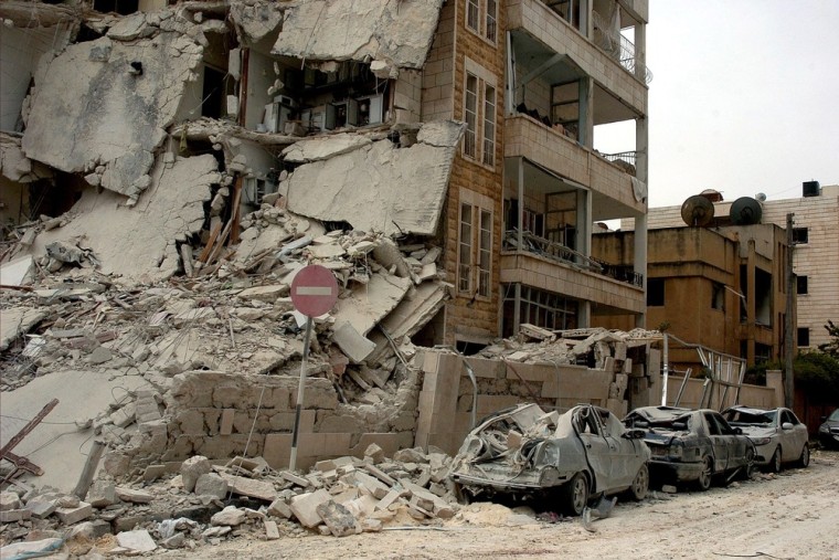EDITOR'S NOTE: Image released by the state-controlled Syrian Arab News Agency (SANA). A damaged building and cars at a site hit by two suicide bombings in Idlib, Syria, on April 30, 2012. According to SANA the bombing killed at least eight people, wounded a hundred others and caused heavy damage. Activists said 20 people were killed and believe the blasts were set off by 'regime agents'.