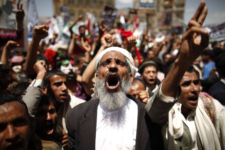 Protesters shout slogans during a demonstration calling for Yemen's former President Ali Abdullah Saleh to be put on trial, in Sanaa on April 30, 2012.