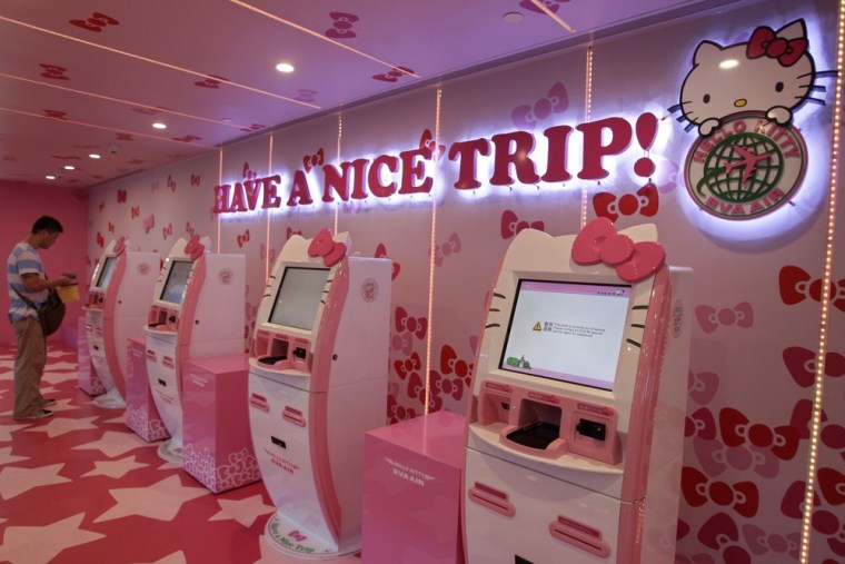A passenger stands next to Eva Airlines' self check-in counters, which are decorated with Hello Kitty motifs, in Taoyuan International Airport, northern Taiwan, April 30, 2012.