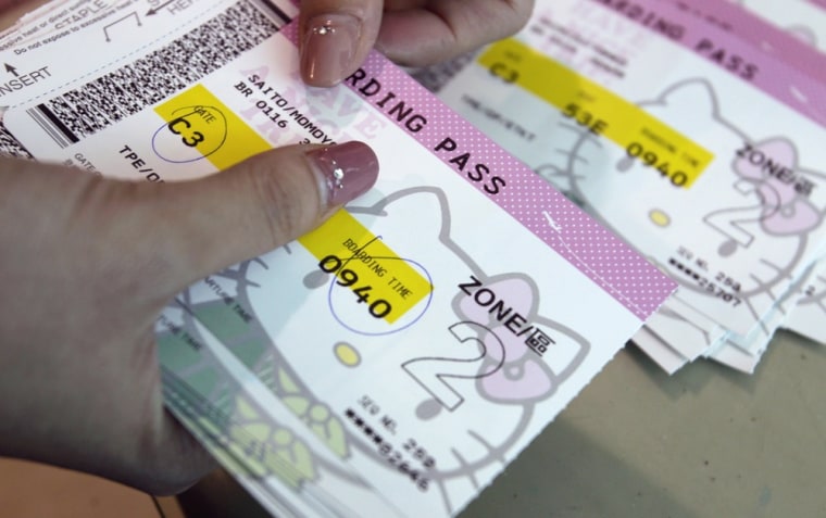 An Eva Airlines ground crew counts Hello Kitty-themed boarding passes in Taoyuan International Airport, northern Taiwan, April 30, 2012.