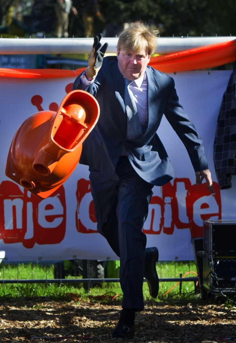 Crown Prince Willem-Alexander of the Netherlands participates in a toilet-bowl-throwing contest in Rhenen on April 30, 2012. The royal family celebrates the annual Queen's Day on April 30.
