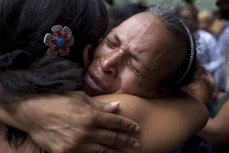 Relatives of inmates cry outside the La Planta prison in Caracas, April 30, after riots erupted inside the prison. Gunshots and explosions were heard inside the prison after a plan for a massive escape was discovered by guards.