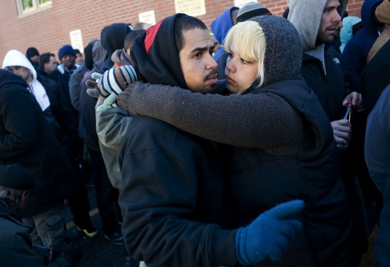 Jestty Martinez hugs his partner and fellow job seeker Aida Munoz after waiting in front of the training offices of Local Union 46.