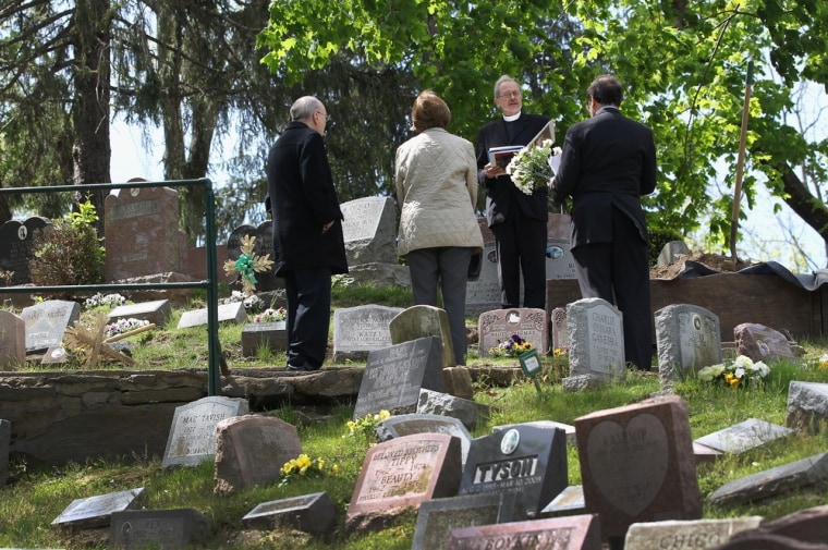 Pet chaplain David James conducts a graveside service for Justin, a twelve-year-old beagle-hound at the Hartsdale Pet Cemetery and Crematory.