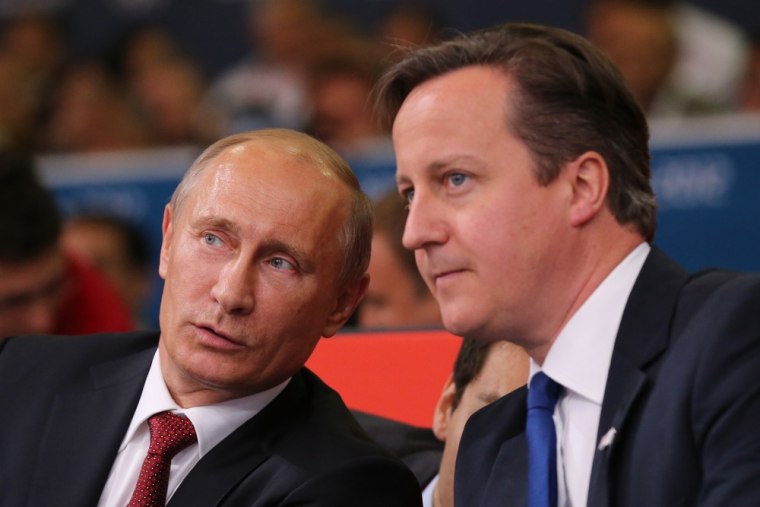 Russian President Vladimir Putin, left, watches judo with British Prime Minister David Cameron on Thursday at the ExCel Centre during the London 2012 Olympic Games.