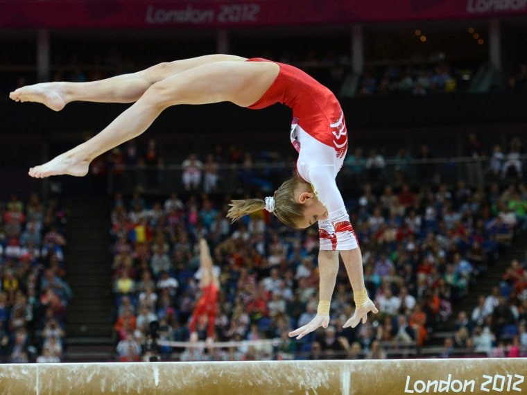 Russia's Victoria Komova performs on the beam on Tuesday in London, her hair held back with a scrunchie.