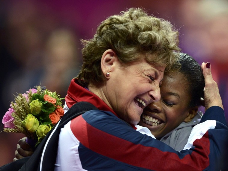 Gabrielle Douglas is hugged by team coordinator Martha Karolyi after winning a gold medal in the women's individual all-around gymnastics final during the London 2012 Olympic Games, Aug. 2, 2012.