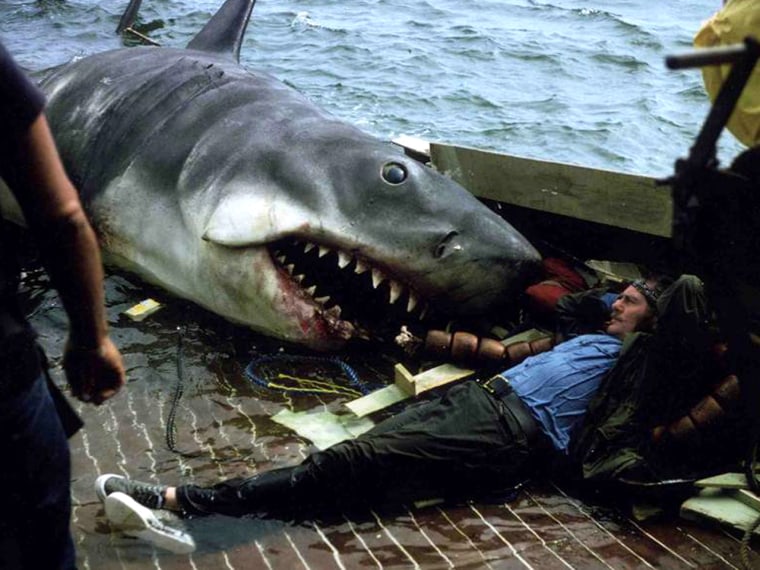Robert Shaw lounges perilously close to his character's nemesis between takes.