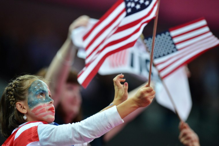 A young US supporter waves a flag after the women' s floor exercise gymnastics final on Aug. 7.