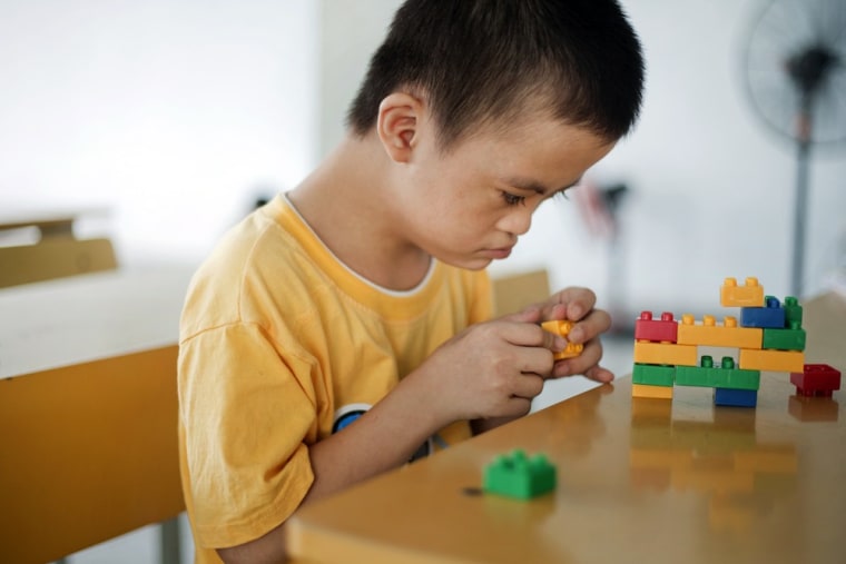 Le Trung Hong Phuc, 9, plays with colored blocks at a rehabilitation center in Danang, Vietnam.