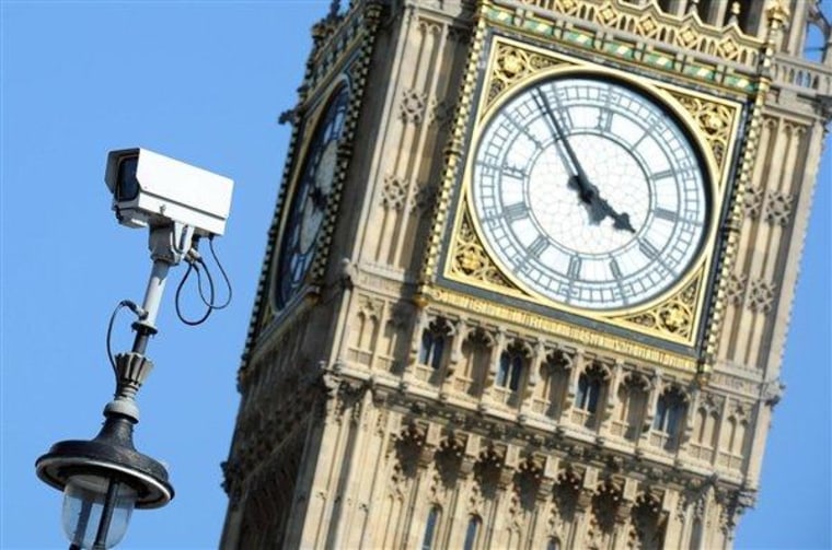 A security camera stands on a lamp post in front of London's iconic Clock Tower, which houses Big Ben, on July 23.