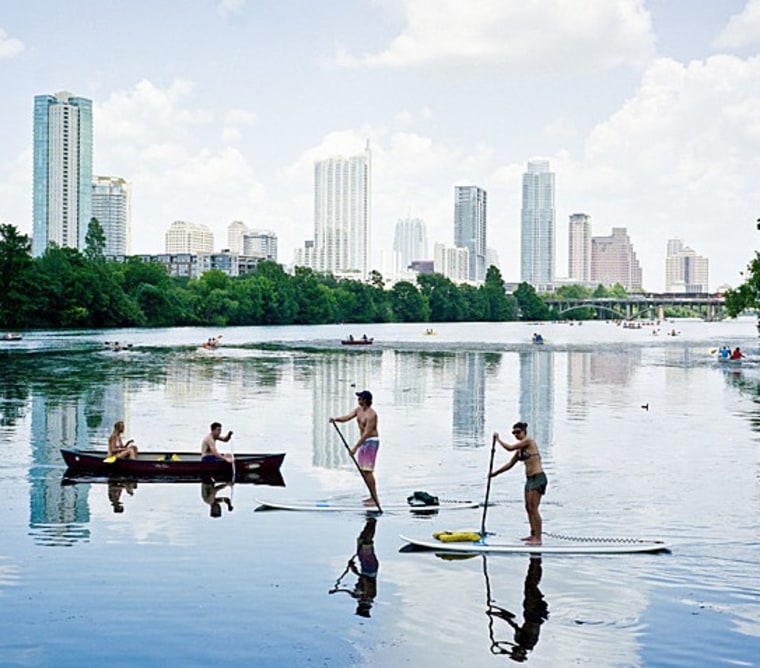 A Travel + Leisure user captured this picture, which frames locals canoeing and paddleboarding with Austin's skyline as a backdrop.