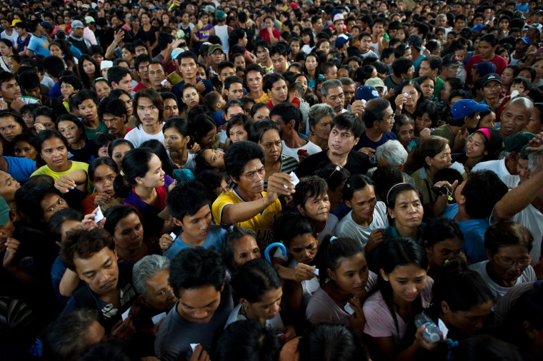 Waiting, wading and mourning in flood-stricken Philippines, as death ...