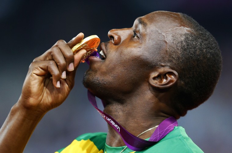 Jamaica's Usain Bolt poses with his gold medal on the podium after winning the men's 200m event at the London 2012 Olympic Games at the Olympic Stadium August 9, 2012.