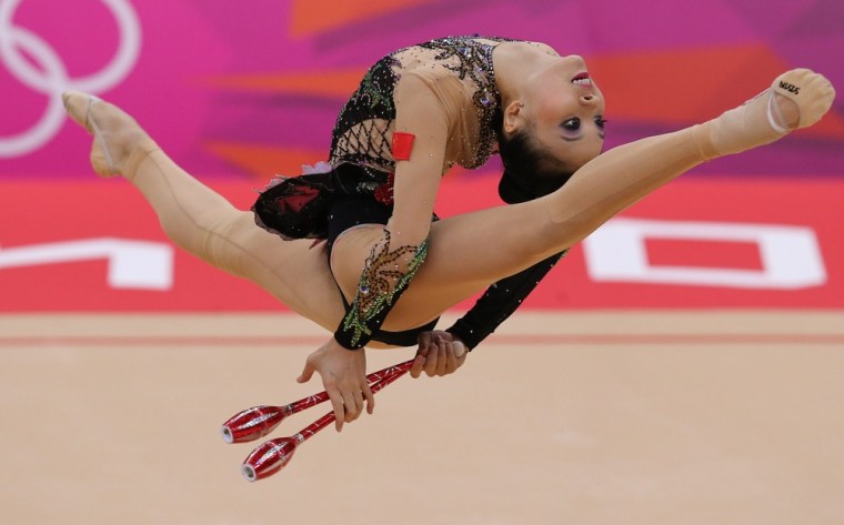 Senyue Deng of China performs on clubs in the Individual All-Around Qualification during the London 2012 Olympic Games Rhythmic Gymnastics competition, Aug. 10.