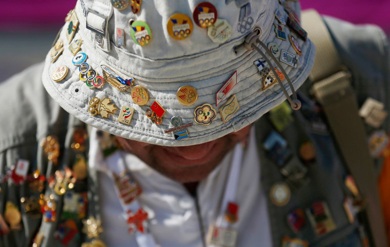 Pin collector Johnny Ioannides of Greece waits outside the Olympic Village in Stratford in east London July 26, 2012.