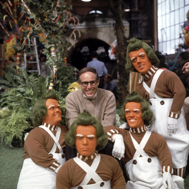 Mel Stuart, director of the 1971 film \"Willy Wonka & the Chocolate Factory,\" poses with the Oompa Loompas characters on the set of the film.