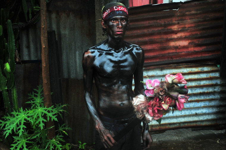 A man covered in motor oil takes part in the festivities honoring Santo Domingo de Guzman, Managua's patron saint on Aug. 10, 2012. Domingo's image spent ten days in the Santo Domingo church and will return to his shrine at the church of Las Sierritas, Managua.