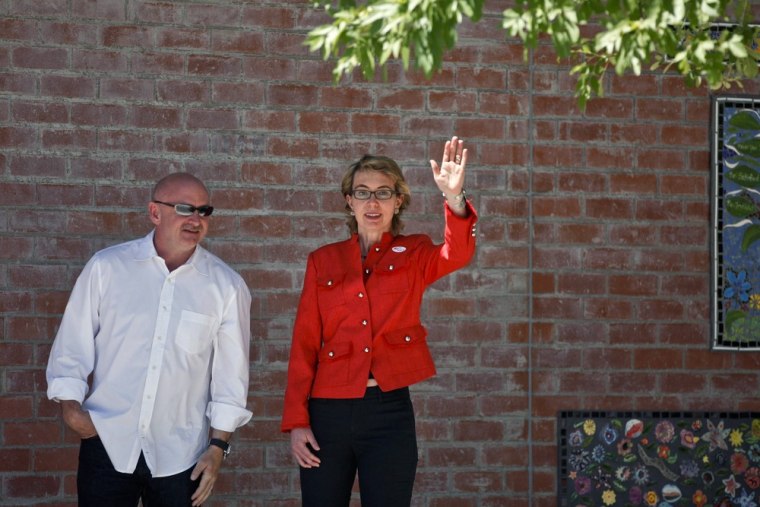 Gabrielle Giffords waves to the crowd with husband Mark Kelly at her side after voting in Tucson on June 12. The Former Arizona congresswoman who was gravely wounded in a mass shooting that left six dead and 12 others wounded, made the move back to Tucson on Sunday.