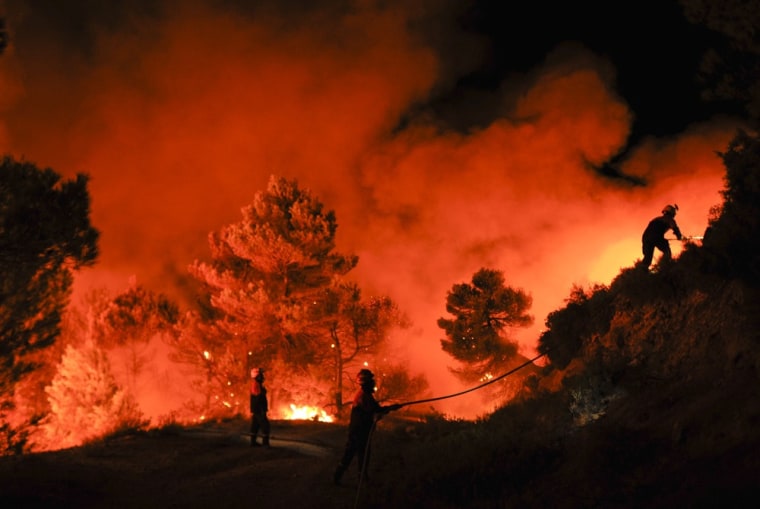Firefighters of Alcoy and Elda try to extinguish a fire in Torre de Macanes, near Alicante, Spain, on August 13, 2012.