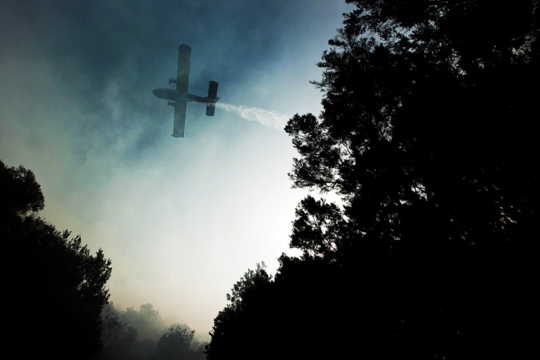 A plane works to extinguish a wildfire in La Gomera in Spain's Canary Islands on August 12, 2012.